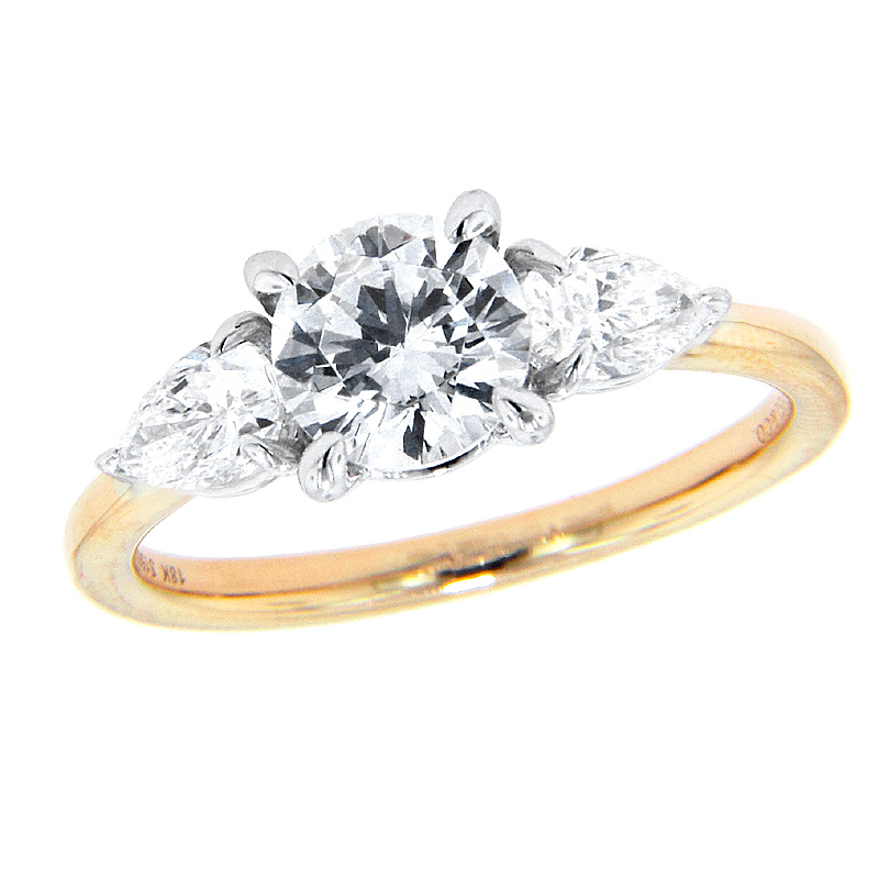 A white and yellow gold diamond three stone engagement ring