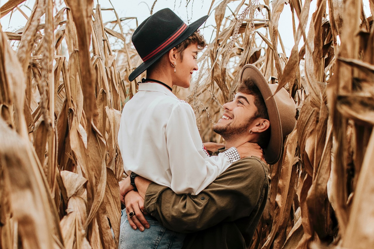 a couple on a date to a seasonal maze while wearing multiple pieces of jewelry together