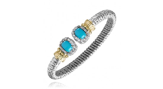 a mixed metal cuff bracelet by Vahan, punctuated with two turquoise gems.