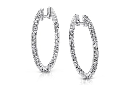 A pair of diamond-adorned hoop earrings from Simon G. are crafted in 18k white gold.