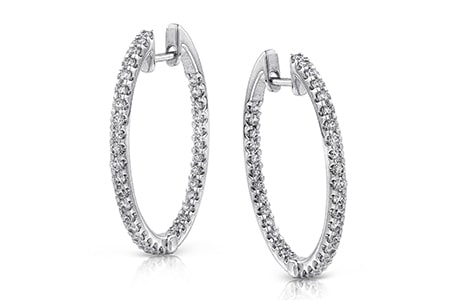 A pair of diamond-adorned hoop earrings from Simon G. are crafted in 18k white gold.