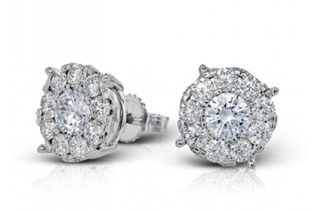 A pair of simple stud earrings from Simon G. feature a diamond halo.