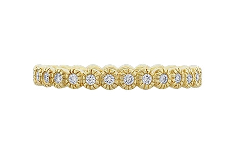 A bezel-set diamond band from Spark Creation features yellow gold.