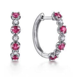 a pair of ruby huggies earrings from Gabriel & Co.’s Lusso Color collection.