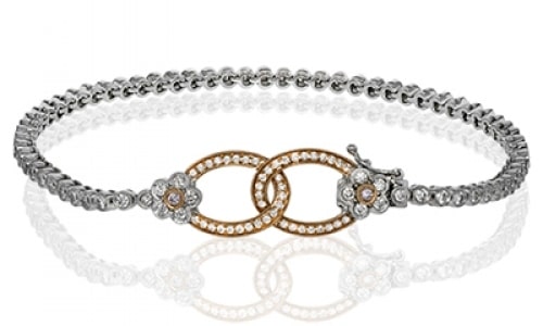 a mixed metal buckle bracelet with diamonds