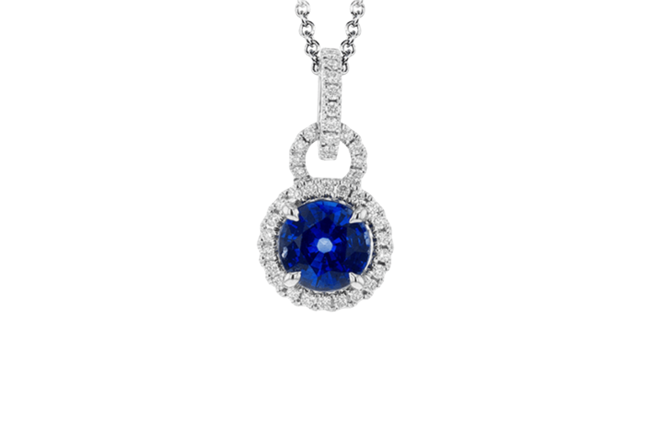 A white gold diamond encrusted pendant with round cut sapphire at the center