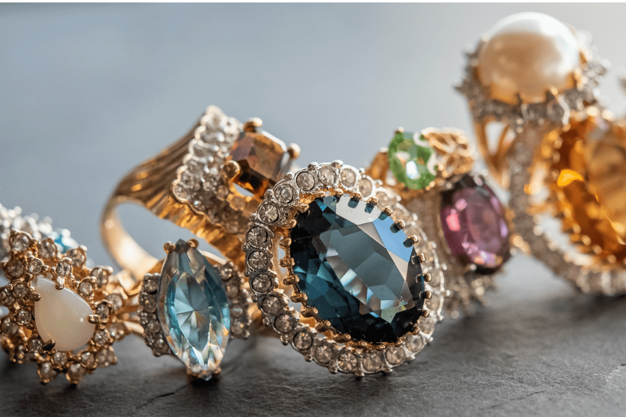 An assortment of rings featuring colored gemstones in vivid hues and elegant settings.