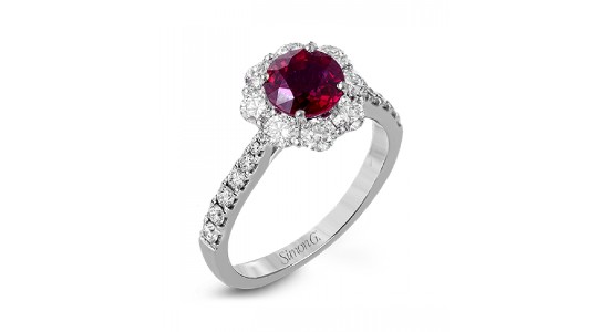 a white gold fashion ring featuring a halo set ruby and diamond side stones