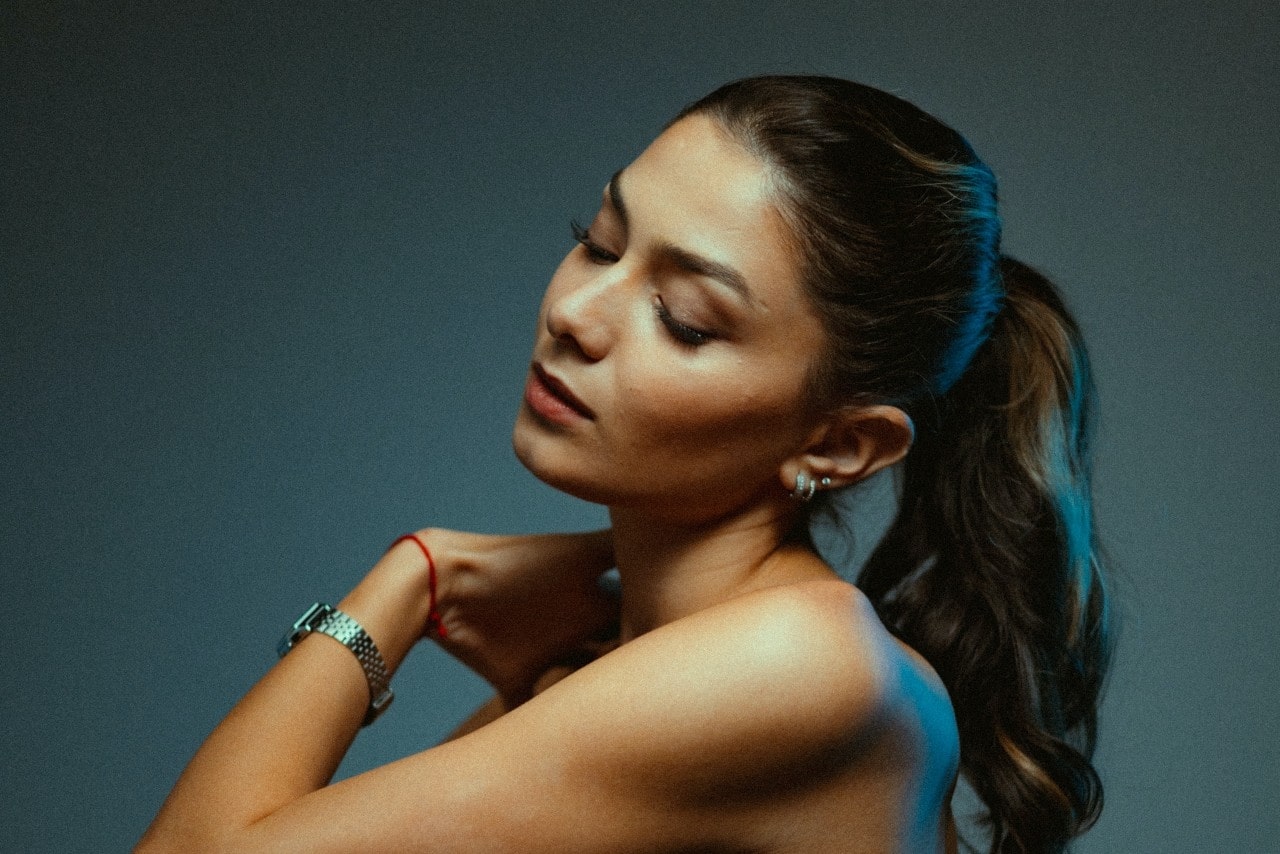 lady with eyes closed wearing a fine watch