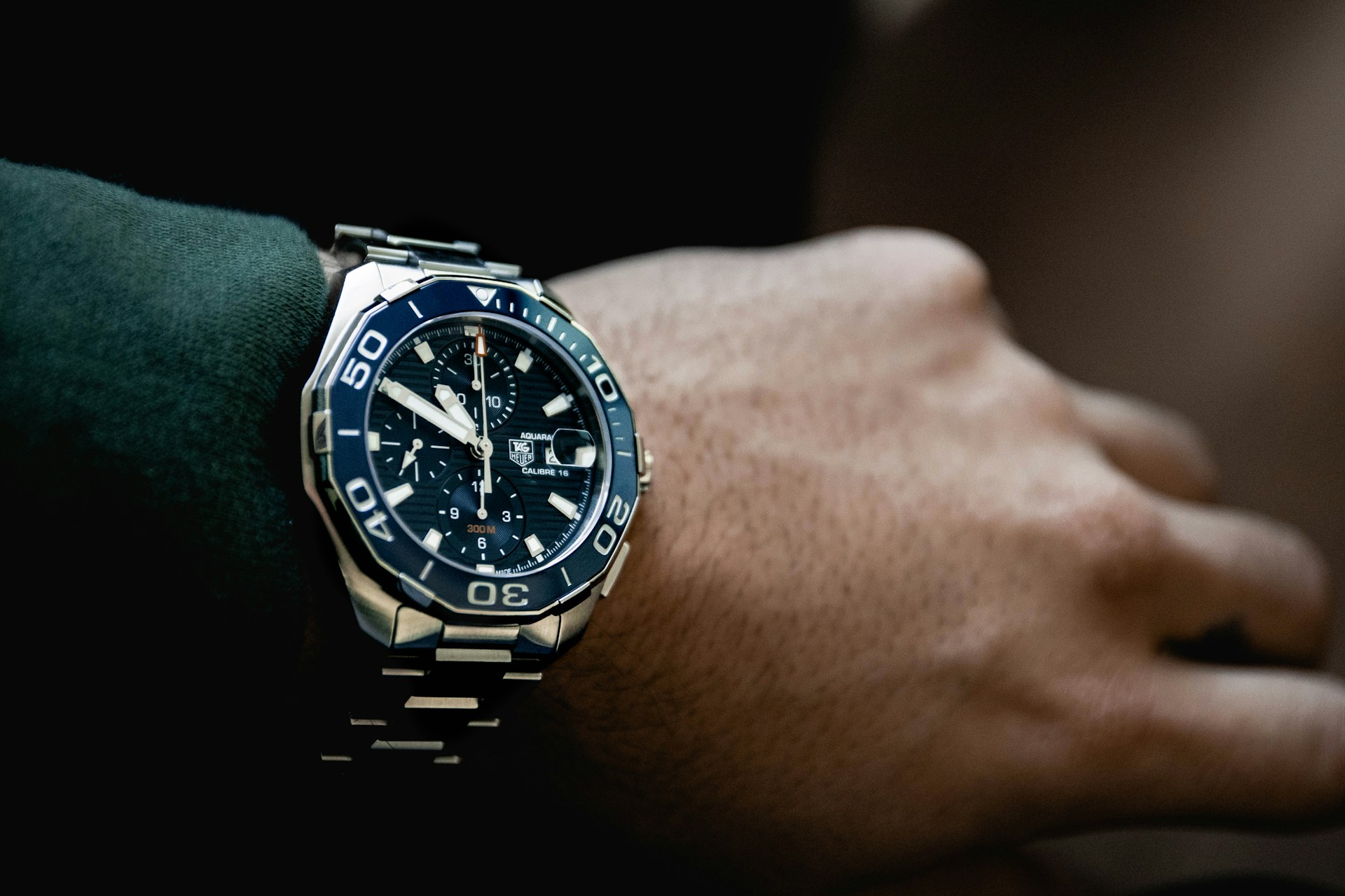 A close-up of a TAG Heuer Aquaracer watch on a man’s wrist. A close-up of a TAG Heuer Aquaracer watch on a man’s wrist.