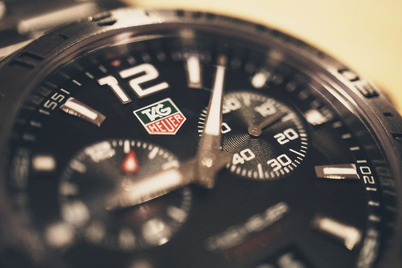 A close-up of a TAG Heuer sports watch, with multiple complications on the dial. A close-up of a TAG Heuer sports watch, with multiple complications on the dial.