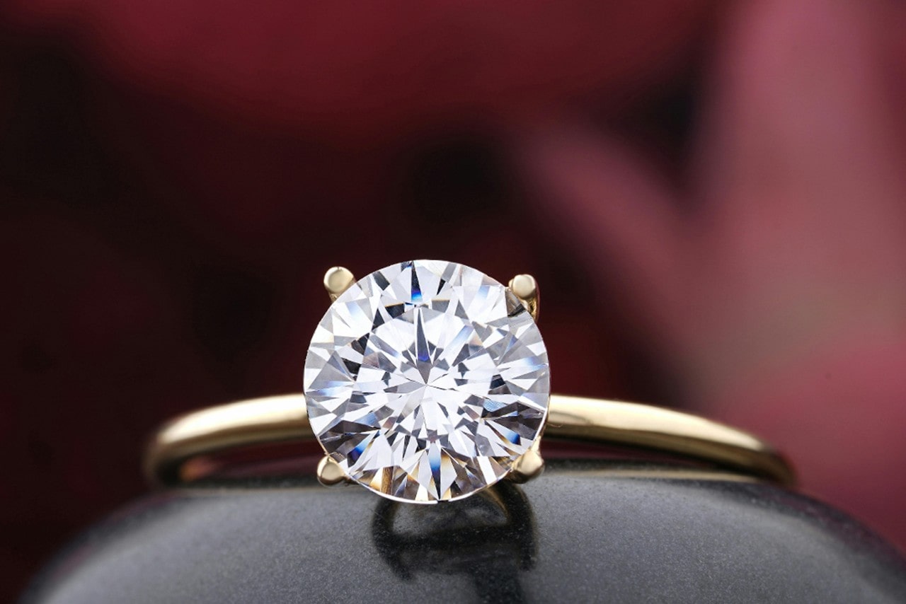 A close-up of a simple yet dazzling diamond solitaire engagement ring.