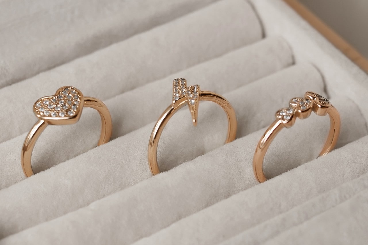 A trio of diamond fashion rings in a velvet ring box.