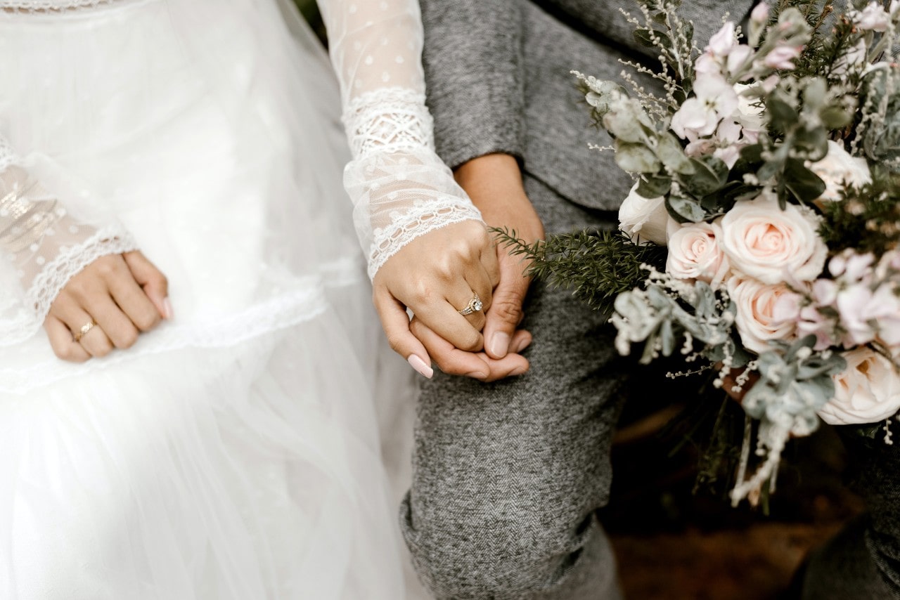 a bride and groom holding hands